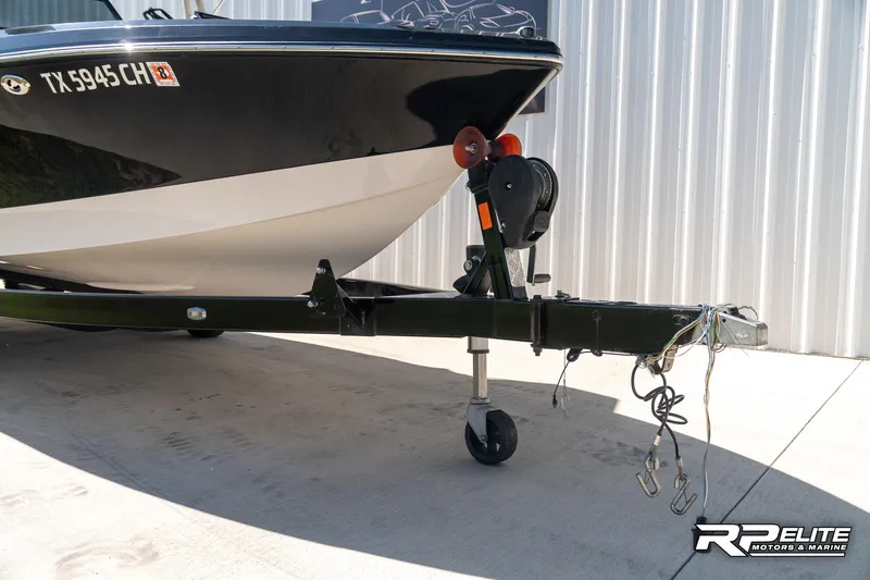 Slide: The Image of 2014 Nautique Super Air Nautique 230 boat on trailer, parked outdoors. - 16