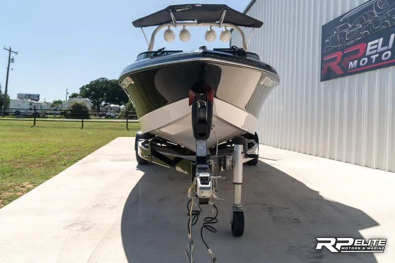 Slide: The Image of 2014 Nautique Super Air Nautique 230 boat on trailer, parked outdoors. - 17