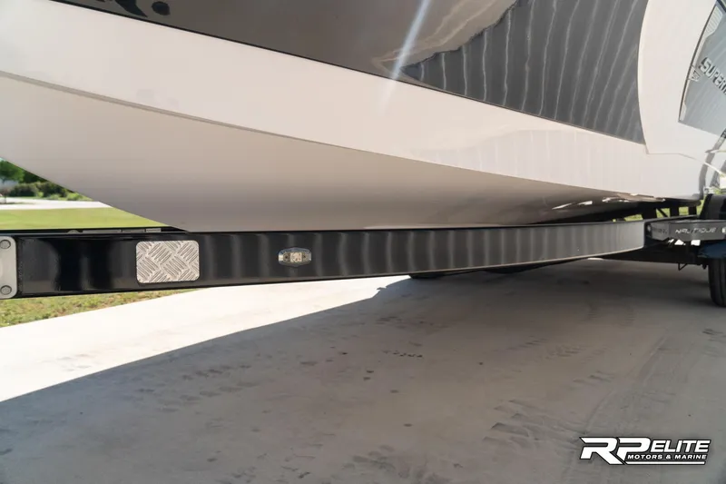 Slide: The Image of 2014 Nautique Super Air Nautique 230 boat on trailer, close-up view. - 19