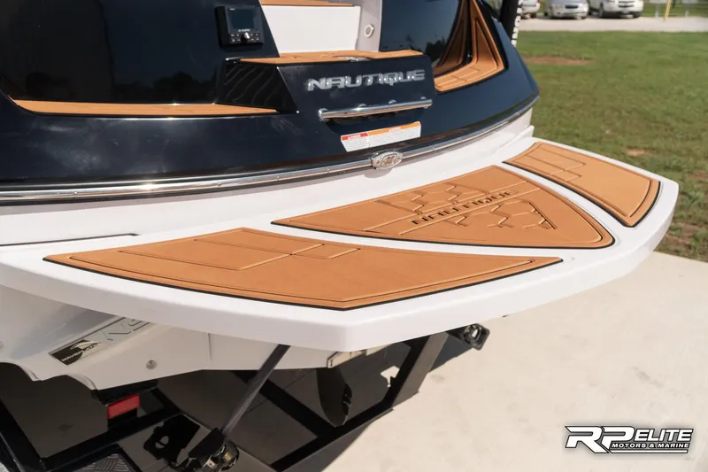 Slide: The Image of 2014 Nautique Super Air Nautique 230 swim platform with teak-style decking. - 27