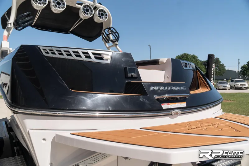 Slide: The Image of 2014 Nautique Super Air Nautique 230 boat with speakers and teak swim platform. - 28