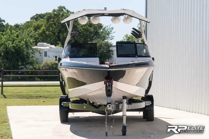 Slide: The Image of 2014 Nautique Super Air Nautique 230 boat on trailer, parked outdoors. - 3