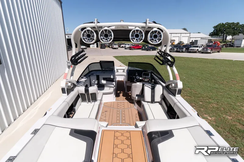 Slide: The Image of 2014 Nautique Super Air Nautique 230 boat interior with speakers and seating. - 33