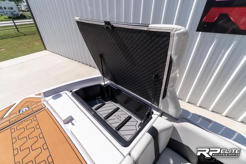 Slide: The Image of 2014 Nautique Super Air Nautique 230 storage compartment open, showcasing interior space. - 38