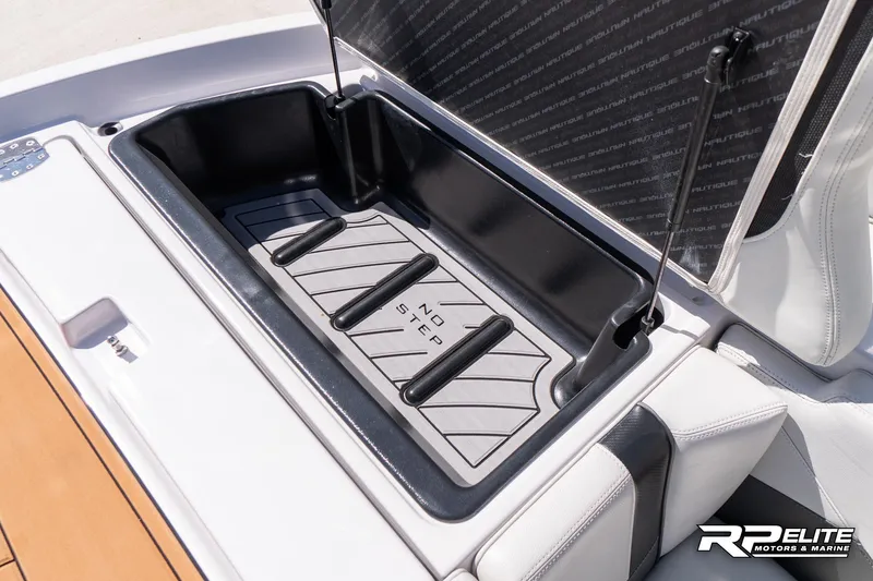 Slide: The Image of 2014 Nautique Super Air Nautique 230 storage compartment with "No Step" warning. - 39