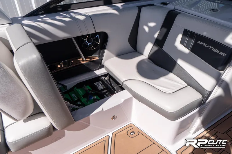 Slide: The Image of 2014 Nautique Super Air Nautique 230 interior seating with storage compartment open. - 43