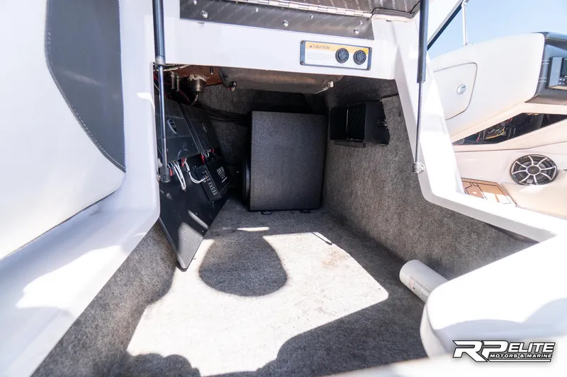 Slide: The Image of 2014 Nautique Super Air Nautique 230 interior storage compartment with carpeted flooring. - 46
