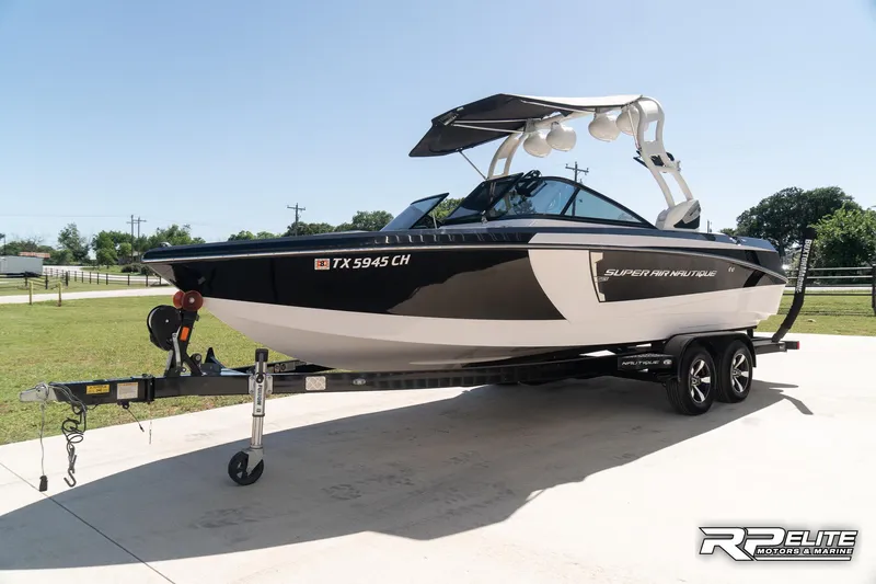 Slide: The Image of 2014 Nautique Super Air Nautique 230 boat on trailer, parked outdoors. - 5