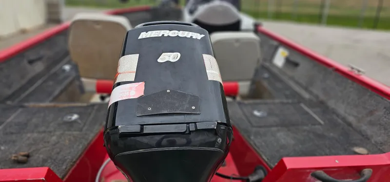 Slide: The Image of 2014 Tracker PG V16 SC boat with Mercury engine, red interior, and dual seating. - 11