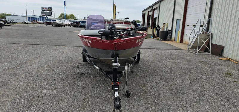 Slide: The Image of 2014 Tracker PG V16 SC boat on trailer in parking lot. - 2