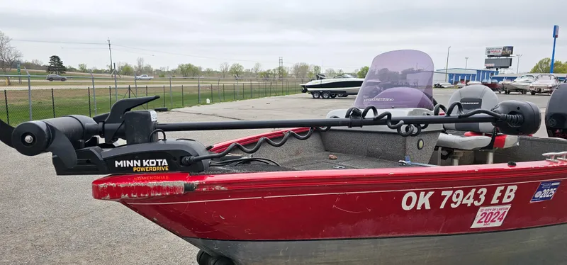Slide: The Image of 2014 Tracker PG V16 SC boat with Minn Kota PowerDrive motor, parked outdoors. - 3