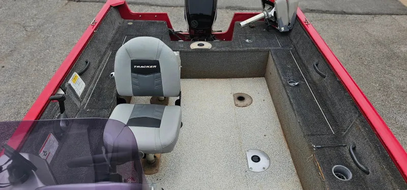 Slide: The Image of 2014 Tracker PG V16 SC boat interior with seating and controls, featuring a red and gray design. - 4