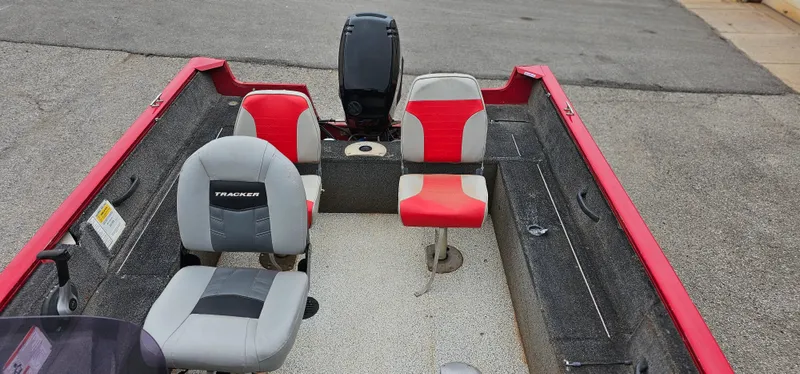 Slide: The Image of 2014 Tracker PG V16 SC boat interior with red and gray seating. - 5