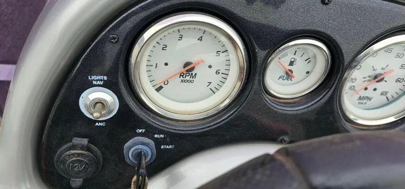 Slide: The Image of Dashboard of a 2014 Tracker PG V16 SC boat with RPM and fuel gauges. - 8
