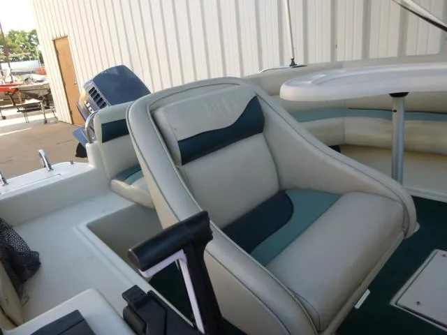 Slide: The Image of Interior of a 2000 SeaArk Sunstar 21 boat with cushioned seating. - 11