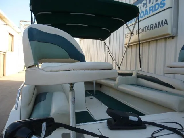 Slide: The Image of SeaArk Sunstar 21 boat, 2000 model, with green and white seating and canopy. - 15