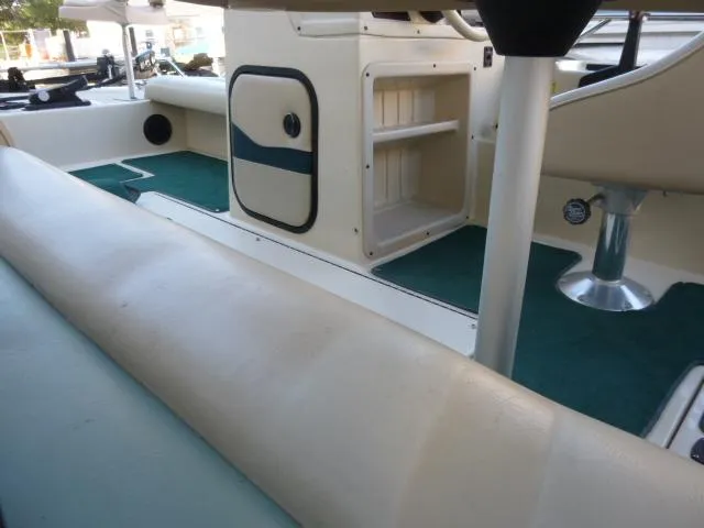 Slide: The Image of Interior of a 2000 SeaArk Sunstar 21 boat with seating and storage compartments. - 26