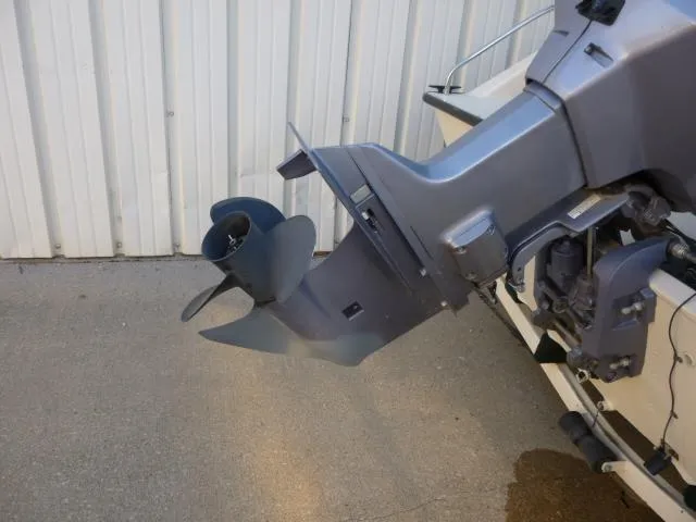 Slide: The Image of Outboard motor of a 2000 SeaArk Sunstar 21 boat, displayed against a metal wall. - 33