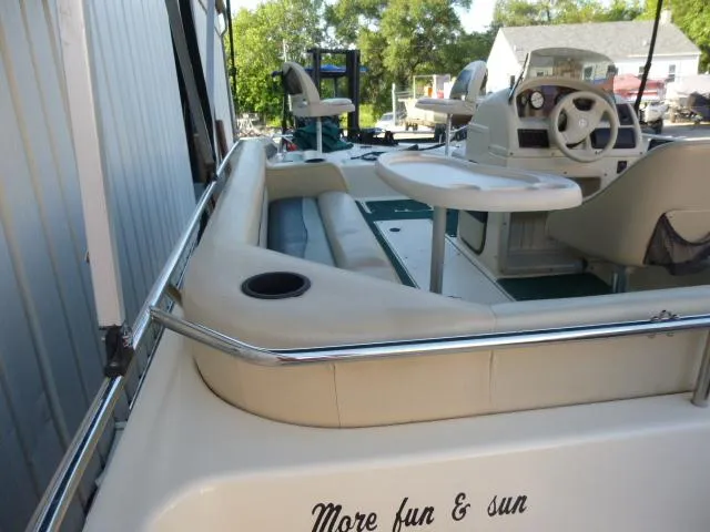 Slide: The Image of 2000 SeaArk Sunstar 21 boat interior with seating and steering wheel. - 5