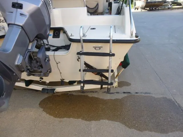 Slide: The Image of Rear view of 2000 SeaArk Sunstar 21 boat with motor and ladder. - 7