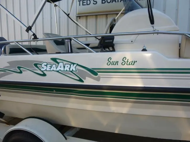 Slide: The Image of SeaArk Sunstar 21 boat, 2000 model, white with green accents, parked at Ted's Boats. - 8