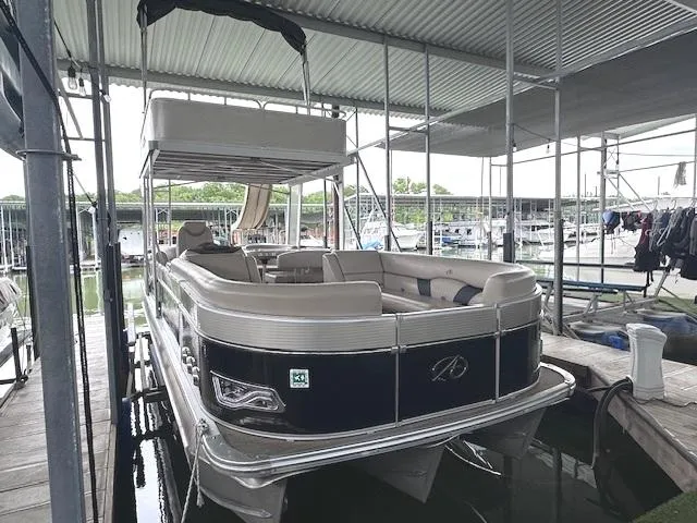 Slide: The Image of 2016 Tahoe Pontoon Vista Funship Entertainer, 27-foot boat docked in marina. - 0