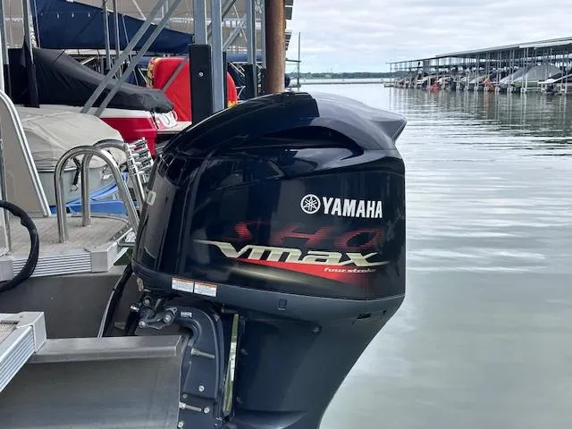 Slide: The Image of Yamaha VMAX outboard motor on 2016 Tahoe Pontoon Vista Funship Entertainer, docked by the water. - 12
