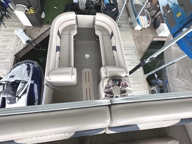 Slide: The Image of 2016 Tahoe Pontoon Vista Funship Entertainer boat interior with beige seating and control panel. - 25