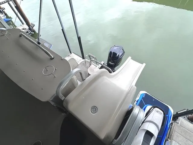 Slide: The Image of 2016 Tahoe Pontoon Vista Funship Entertainer with slide, docked on calm water. - 28