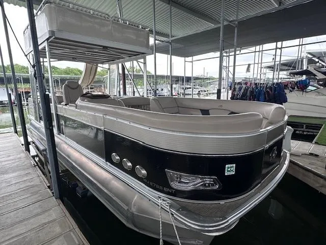 Slide: The Image of 2016 Tahoe Pontoon Vista Funship Entertainer, 27-foot boat docked in a marina. - 3