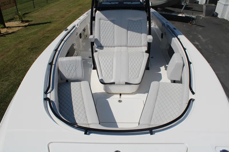 Slide: The Image of 2023 Fountain 34 CC boat interior with luxurious white seating and sleek design. - 10
