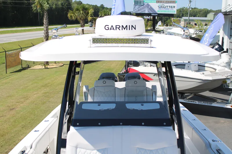 Slide: The Image of 2023 Fountain 34 CC boat with Garmin equipment, displayed outdoors. - 12