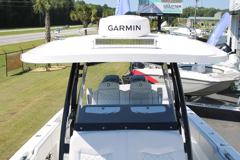 Slide: The Image of 2023 Fountain 34 CC boat with Garmin equipment, parked outdoors. - 13