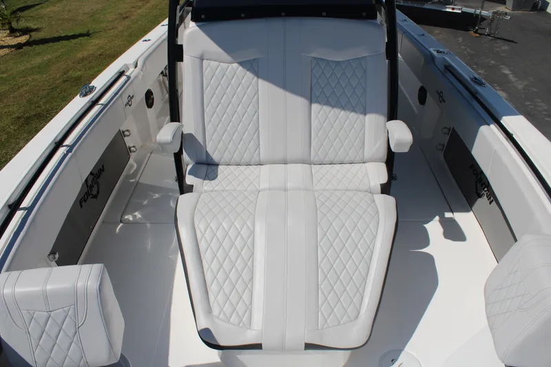 Slide: The Image of 2023 Fountain 34 CC boat with luxurious white quilted seating and sleek design. - 15