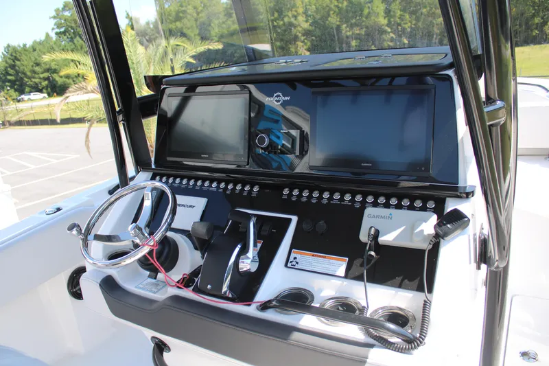 Slide: The Image of 2023 Fountain 34 CC boat dashboard with steering wheel and navigation screens. - 17