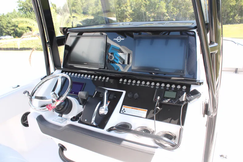 Slide: The Image of 2023 Fountain 34 CC boat dashboard with modern controls and navigation screens. - 18