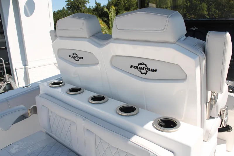 Slide: The Image of 2023 Fountain 34 CC boat seats with cup holders, featuring sleek white design. - 19