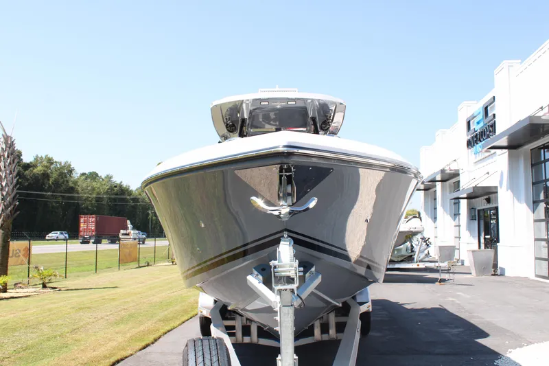 Slide: The Image of 2023 Fountain 34 CC boat on trailer outside dealership. - 2
