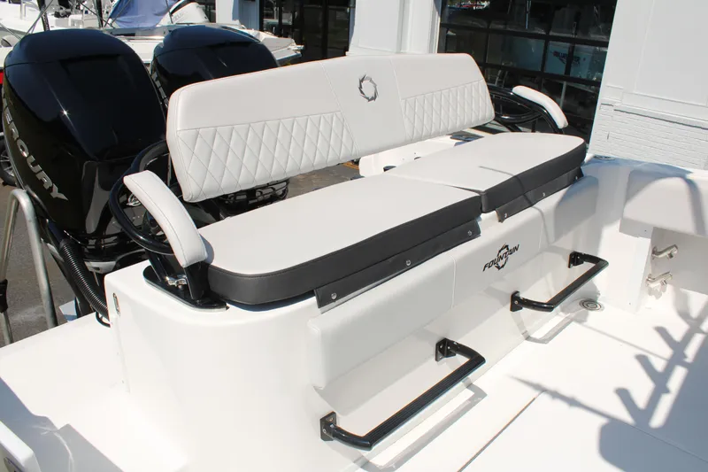 Slide: The Image of 2023 Fountain 34 CC boat seating area with dual Mercury engines in the background. - 23
