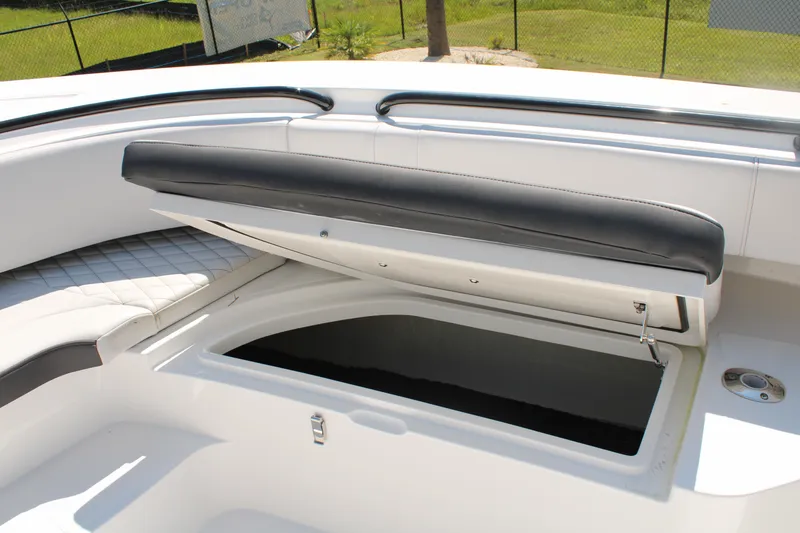 Slide: The Image of 2023 Fountain 34 CC boat with open storage compartment and cushioned seating. - 28