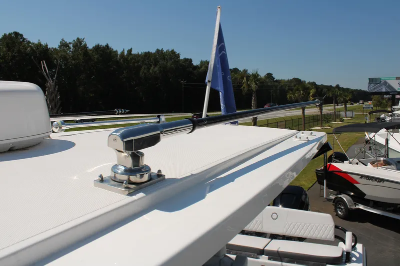 Slide: The Image of 2023 Fountain 34 CC boat with sleek design and mounted flagpole. - 32