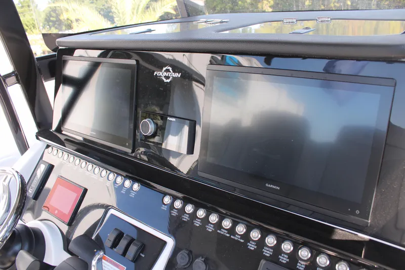 Slide: The Image of Dashboard of 2023 Fountain 34 CC boat with modern navigation screens. - 34