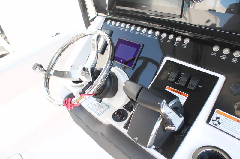 Slide: The Image of 2023 Fountain 34 CC boat dashboard with steering wheel and control panel. - 35