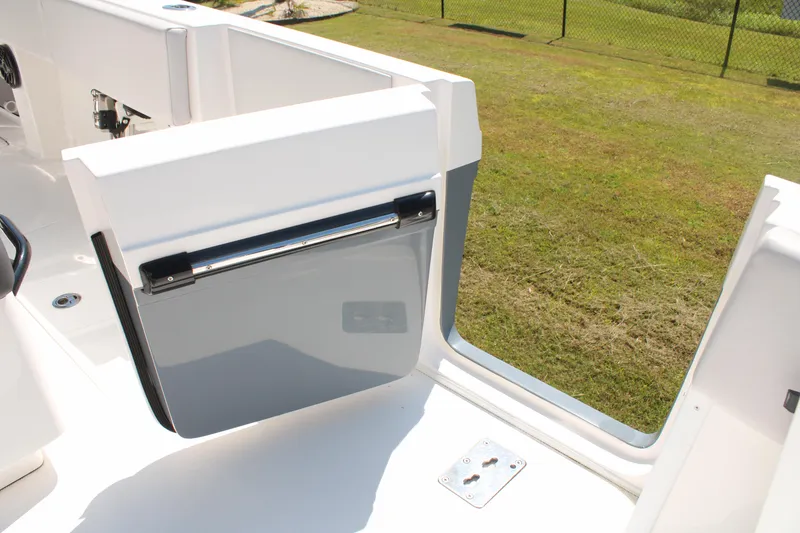 Slide: The Image of 2023 Fountain 34 CC boat with open side door, grassy background. - 37