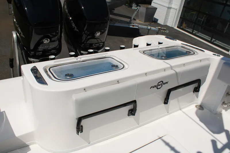 Slide: The Image of 2023 Fountain 34 CC boat with dual livewells and powerful outboard engines. - 38
