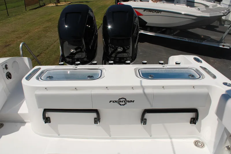 Slide: The Image of 2023 Fountain 34 CC boat with dual outboard motors and livewell compartments. - 40