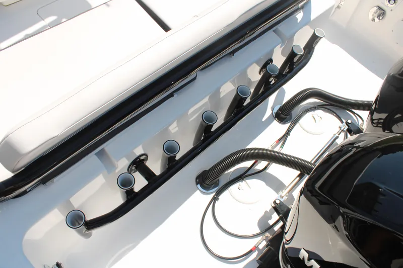 Slide: The Image of 2023 Fountain 34 CC boat interior with rod holders and engine components. - 43