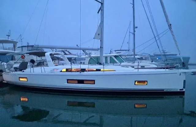 Slide: The Image of 2023 Beneteau Oceanis 46.1 yacht docked at marina during twilight. - 0
