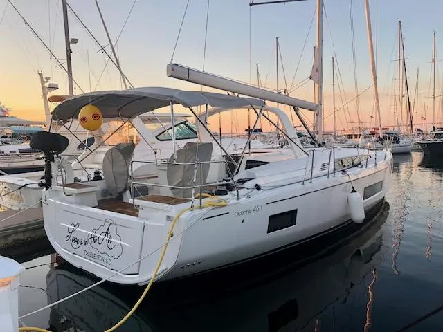 Slide: The Image of 2023 Beneteau Oceanis 46.1 sailboat docked at sunset in a marina. - 1