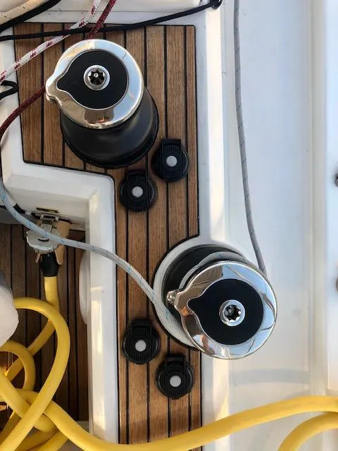 Slide: The Image of Deck winches on 2023 Beneteau Oceanis 46.1 yacht with teak finish and ropes. - 11